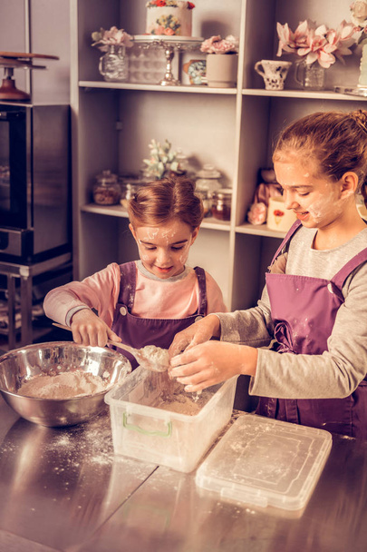 Cheerful nice children trying to make a cake - Fotoğraf, Görsel