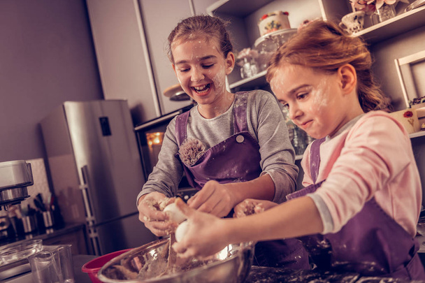 Joyful nice girls studying in the cooking academy - Фото, изображение