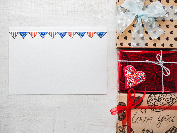 Blank Notepad Page for sweet words about love, bright gift boxes and confetti on a wooden white surface of the boards. Closeup, flat lay. Congratulations for loved ones, relatives, friends, colleagues - Foto, Imagem