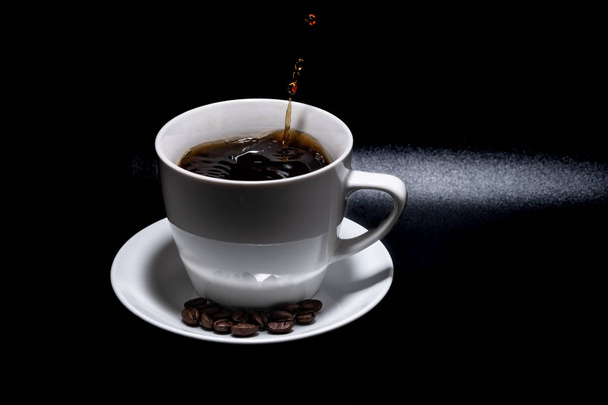 White cup and saucer with coffee on a black background - Foto, Imagen