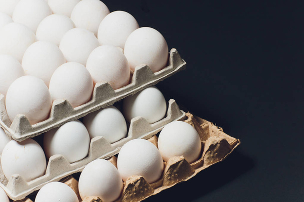 Several white eggs in an egg carton. - Foto, Imagen