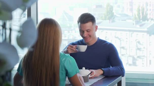Handsome cheerful man having date with his girlfriend, enjoying breakfast together - Πλάνα, βίντεο