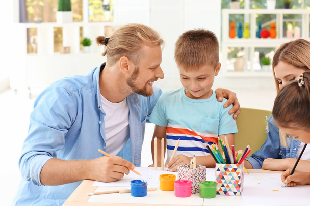 Cute children drawing with parents at home - Φωτογραφία, εικόνα