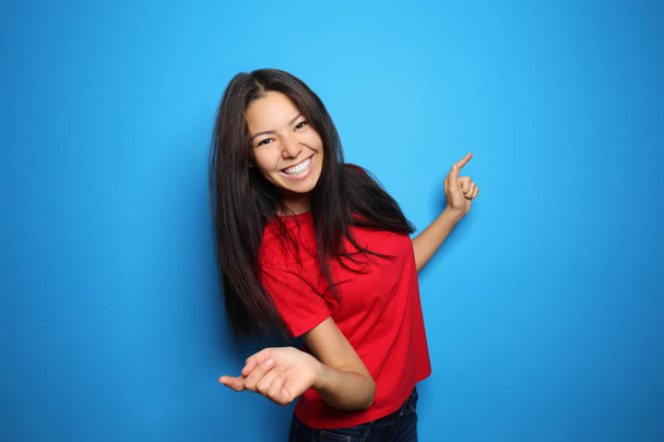 Attractive young woman posing on color background - Photo, Image