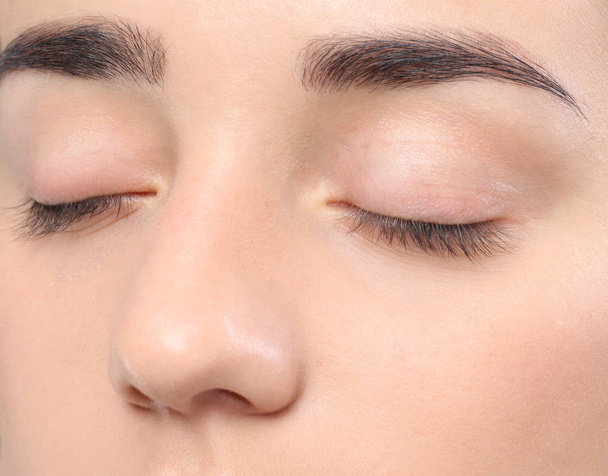 Young woman with beautiful natural eyelashes, closeup view - Фото, изображение