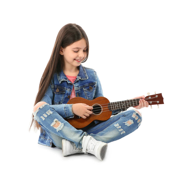 Little cheerful girl playing guitar, isolated on white - Zdjęcie, obraz