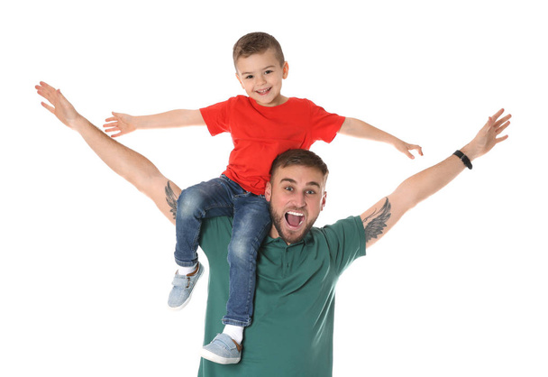 Father and son having fun on white background - Foto, afbeelding