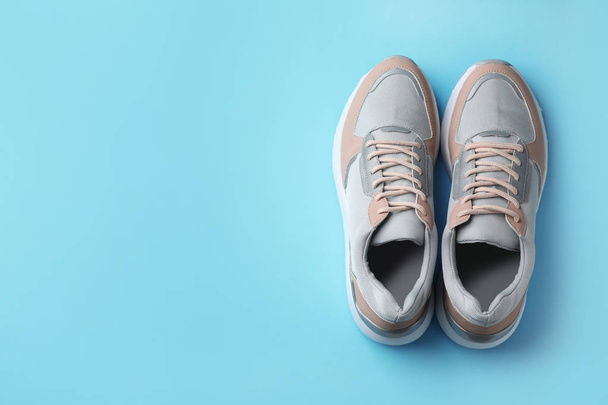 Pair of stylish sneakers on color background, top view. Space for text - Foto, afbeelding