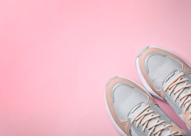 Pair of stylish sneakers on color background, top view. Space for text - Zdjęcie, obraz