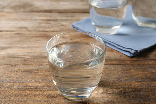 Glass of fresh water on wooden table - Photo, image