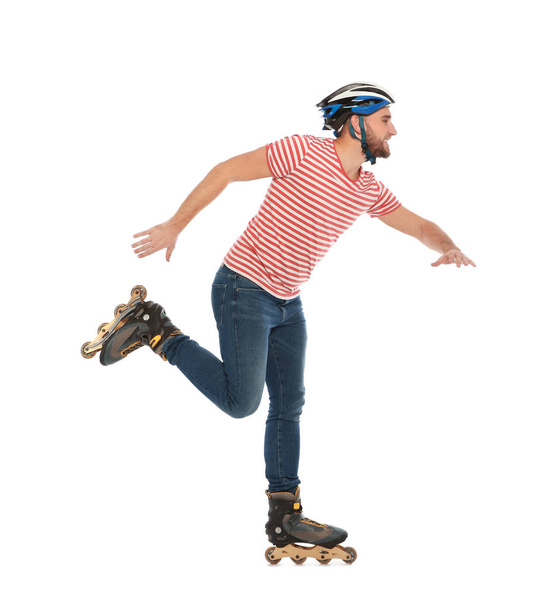 Young man with inline roller skates on white background - Фото, изображение