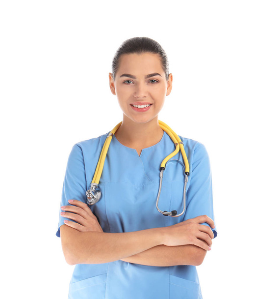 Portrait of young medical assistant with stethoscope on white background - Foto, imagen
