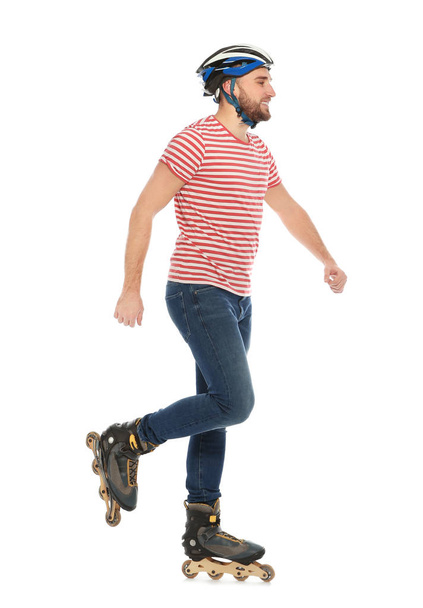 Young man with inline roller skates on white background - Zdjęcie, obraz