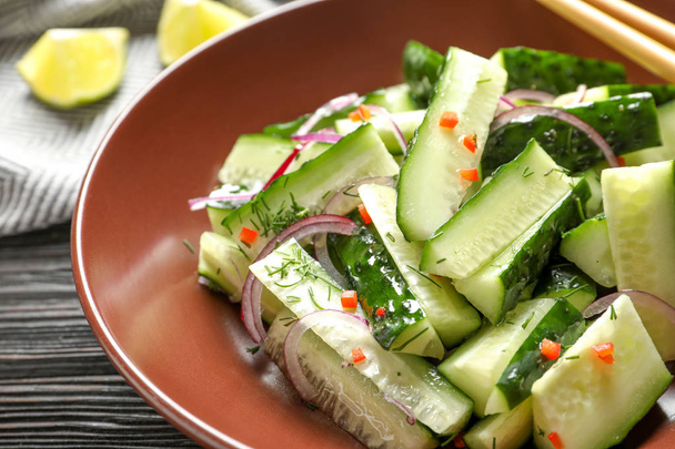 Delicious cucumber salad with onion on plate, closeup - Fotó, kép