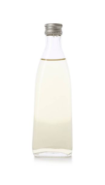 Glass bottle of apple vinegar on white background - Valokuva, kuva