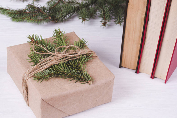 SONY DSChristmas gift box and old books on a white wooden background. Christmas & New Year leisure  concept - Foto, imagen