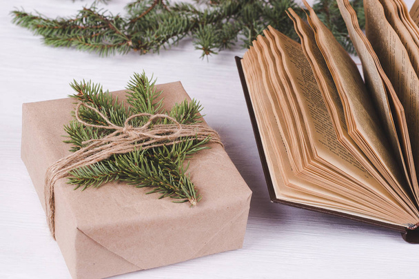 SONY DSChristmas gift box and old books on a white wooden background. Christmas & New Year leisure  concept - Foto, imagen