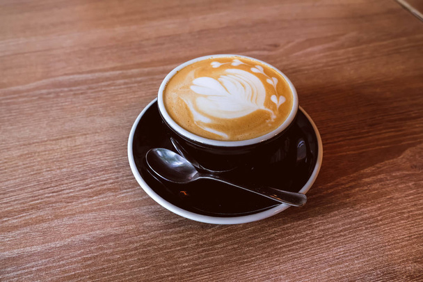 Hot Latte Coffee on wooden floor - Fotó, kép