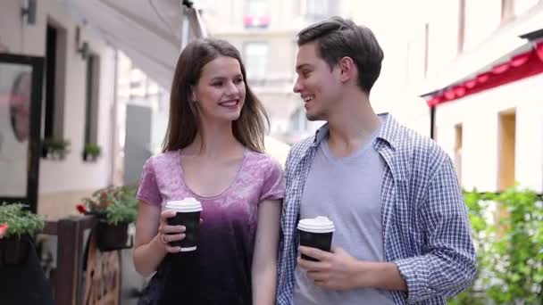 Young People Drinking Coffee And Walking At City Street - Materiał filmowy, wideo