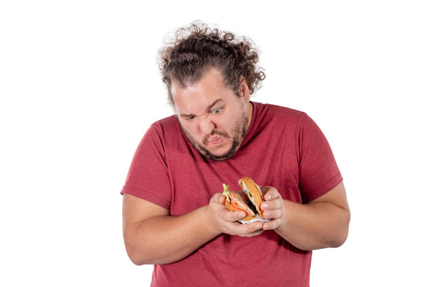 Funny fat man eating hamburger. Fast food, unhealty eat - Valokuva, kuva