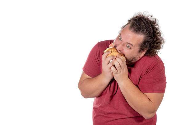 Funny fat man eating hamburger. Fast food, unhealty eat - Foto, immagini