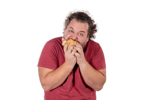 Funny fat man eating hamburger. Fast food, unhealty eat - Photo, Image
