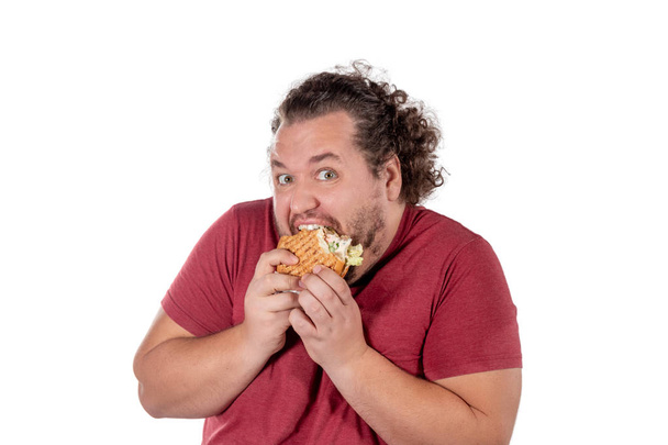 Funny fat man eating hamburger. Fast food, unhealty eat - Photo, Image
