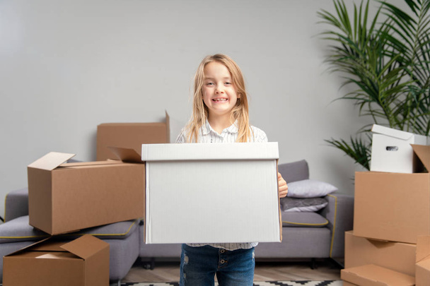 Image of girl with cardboard box in her hands - Фото, зображення