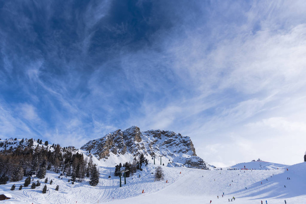 Winter in Dolomites Mountains, people ski on hill, ski resort - Foto, Imagen