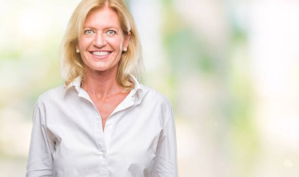Middle age blonde business woman over isolated background with a happy and cool smile on face. Lucky person. - Photo, Image