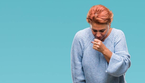 Atrractive senior caucasian redhead woman wearing winter sweater over isolated background feeling unwell and coughing as symptom for cold or bronchitis. Healthcare concept. - Photo, Image