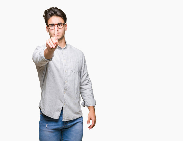 Young handsome man wearing glasses over isolated background Pointing with finger up and angry expression - Valokuva, kuva