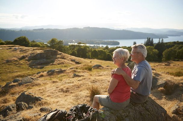 Senior Couple Resting At Top Of Hill in mountains  - Photo, image