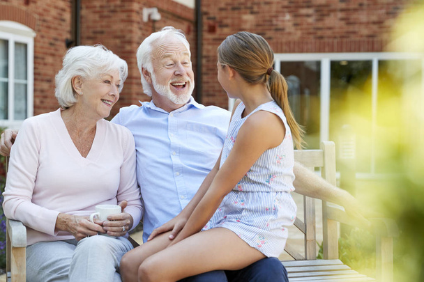 Granddaughter Talking With Grandparents During Visit To Retirement Home - Fotó, kép