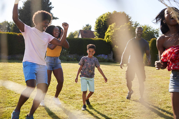 Adult family playing football with son celebrate goal - Photo, Image