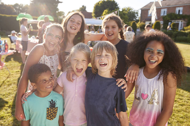Group Portrait Of children Attending Summer Garden Fete, looking at camera  - Photo, image
