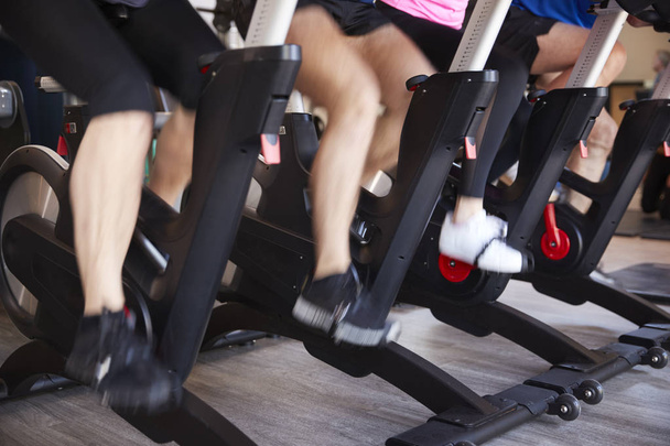 sport gym with people, partial view of human legs on exercise bikes - Foto, Imagem