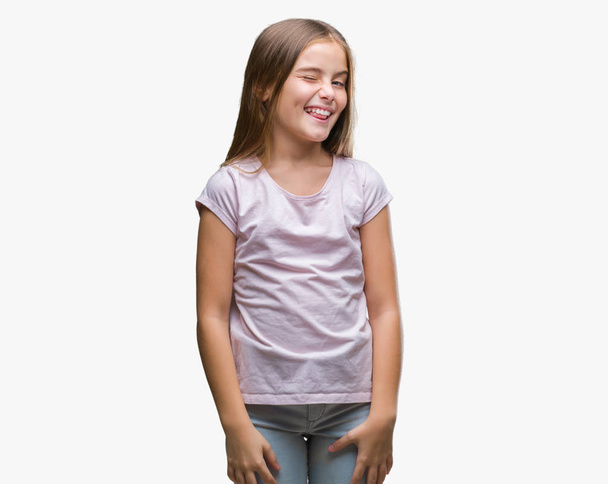Young beautiful girl over isolated background winking looking at the camera with sexy expression, cheerful and happy face. - Photo, Image