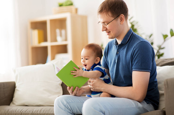 heureux père et petit bébé fils avec livre à la maison
 - Photo, image