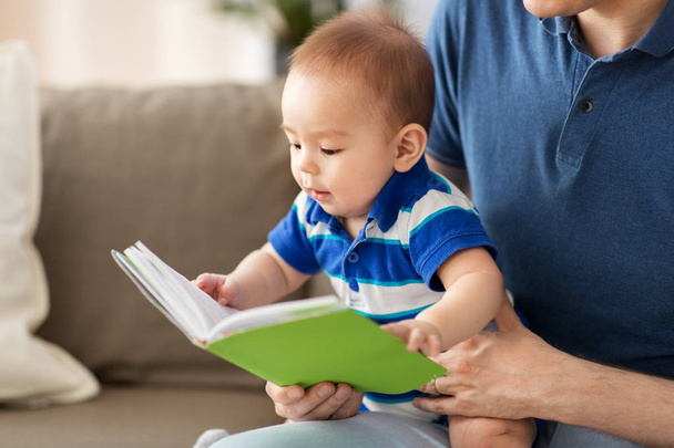 baby boy and father with book at home - Φωτογραφία, εικόνα