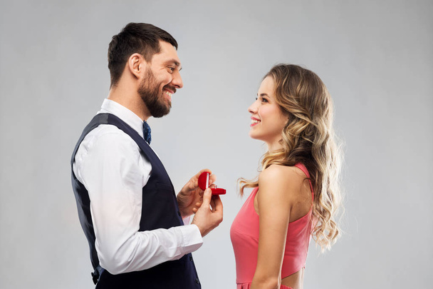 man giving woman engagement ring on valentines day - Photo, Image