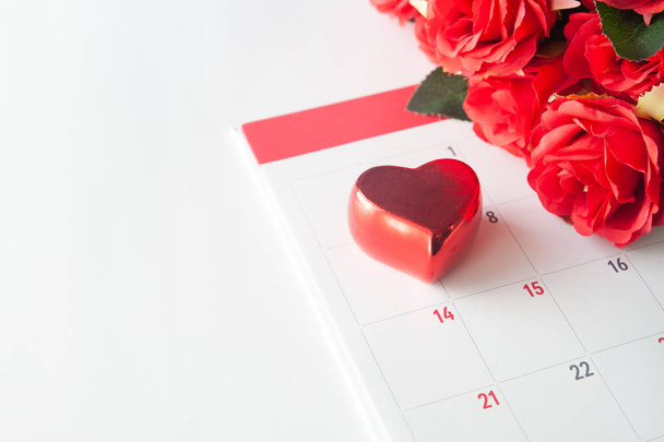 Close up red heart on calendar with red rose, Valentine concept - Foto, imagen