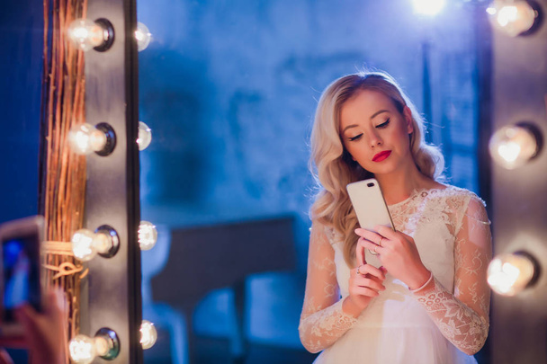 Beautiful girl taking selfie in mirror - Фото, изображение