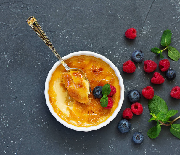 Creme brulee. dessert with caramel crust and berries. - Photo, Image