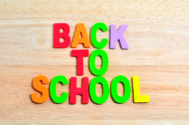 Back to School text with shadow on wooden background - 写真・画像