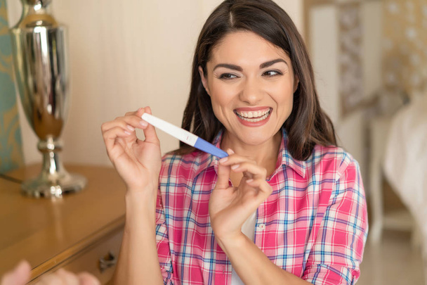 Showing one stripe of pregnancy test. Happiness - Valokuva, kuva