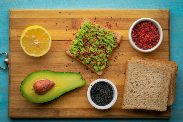 Avocado toast and ingredients for cooking. - Photo, Image