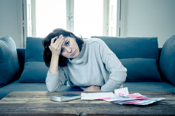 Young attractive woman looking stressed and worried with card payments and home finances accounting costs charges taxes and mortgage in paying bills financial problems and credit card debts concept. - Fotoğraf, Görsel