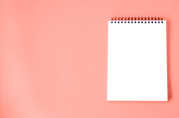 Notepad is isolated on a blue background. There is a place for text, logo. - Photo, Image