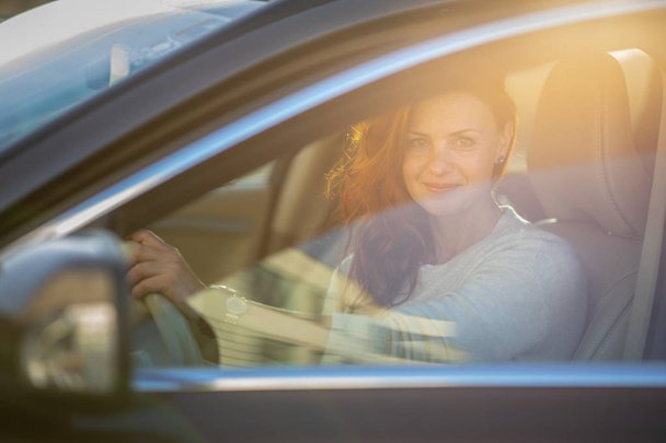 Pretty, young woman  driving a car -Invitation to travel. Car rental or vacation. - Φωτογραφία, εικόνα